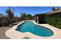 Backyard view of a kidney-shaped pool with plenty of room for entertaining at 9402 N 48Th Dr, Glendale, AZ 85302