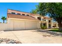 Captivating home featuring a three-car garage, well-manicured lawn, and lovely, mature landscaping at 119 E Palomino Dr, Tempe, AZ 85284