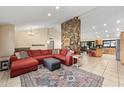 Open concept living room with a striking stone fireplace and seamless flow to the dining area at 14221 N 43Rd St, Phoenix, AZ 85032