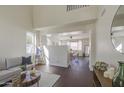 Bright living room featuring wood floors, neutral-toned furniture, high ceilings, and lots of light at 14719 N 176Th Ave, Surprise, AZ 85388