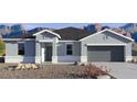 Charming single-story home with a two-car garage and desert landscaping in front at 1534 E Mason Dr, Casa Grande, AZ 85122
