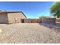 Spacious side yard with rock landscaping and gated entrance perfect for extra storage or outdoor activities at 15656 W Desert Mirage Dr, Surprise, AZ 85379