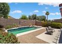A private backyard with a swimming pool, desert landscaping, and privacy wall at 15790 W Arrowhead Dr, Surprise, AZ 85374