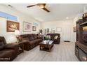 Open living room with hardwood floors, decorative ceiling fan and modern design elements at 15790 W Arrowhead Dr, Surprise, AZ 85374