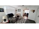 Bright living room with a neutral color scheme and a view into another room at 17200 W Bell Rd # 1622, Surprise, AZ 85374
