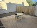 Cozy backyard patio with brick pavers and a small outdoor table set at 1913 S River Dr, Tempe, AZ 85281