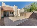 Private backyard with a paved patio, wooden fence, and outdoor seating area for relaxing or entertaining at 1913 S River Dr, Tempe, AZ 85281