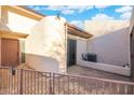 Private patio with stucco walls and an AC unit, perfect for outdoor relaxation and easy access from the interior at 1913 S River Dr, Tempe, AZ 85281
