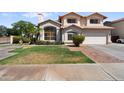 Two-story home featuring a two-car garage and desert landscaping at 2024 N 125Th Ave, Avondale, AZ 85392