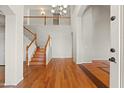 Grand foyer with hardwood floors, staircase, and high ceilings at 2024 N 125Th Ave, Avondale, AZ 85392