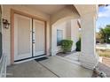 Front porch with a double door entry and stucco columns at 2024 N 125Th Ave, Avondale, AZ 85392