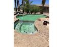 Beautiful in-ground pool featuring a spa, rock waterfall, and lush landscaping at 20332 N Denizen Dr, Surprise, AZ 85387