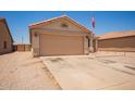 Beautiful home featuring a spacious driveway and a two-car garage, surrounded by well-maintained desert landscaping at 2202 S Lawther Dr, Apache Junction, AZ 85120