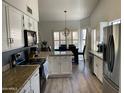 Bright kitchen with white cabinets, granite countertops, and stainless steel appliances at 2723 E Rockledge Rd, Phoenix, AZ 85048