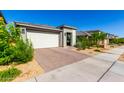 Street view of a modern home with a well-manicured lawn featuring a two-car garage and neutral color palette at 32611 N 20Th Dr, Phoenix, AZ 85085
