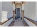 A welcoming entryway featuring a decorative front door and stone pillars at 35701 N Bandolier Dr, San Tan Valley, AZ 85144