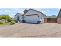 Lovely single-story home displaying a stone facade, attached two-car garage and brick paver driveway at 35701 N Bandolier Dr, San Tan Valley, AZ 85144