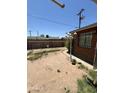 Fenced backyard with sparse landscaping and privacy wall in need of some renovation at 3701 W Keim Dr, Phoenix, AZ 85019