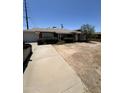 Single level brick home with attached garage and dry landscaping in need of renovation at 3701 W Keim Dr, Phoenix, AZ 85019
