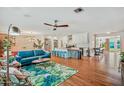 Spacious open-concept living area with hardwood floors, a modern sofa, and seamless flow to the kitchen at 4036 N 40Th Pl, Phoenix, AZ 85018