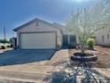 Front view of a single-Gathering house featuring a two-car garage and desert landscaping at 4104 N 113Th Ave, Phoenix, AZ 85037