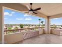 Enjoy city views from this balcony with tile flooring and decorative partition, illuminated by a ceiling fan at 4200 N Miller Rd # 504, Scottsdale, AZ 85251
