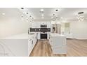 Gourmet kitchen featuring stainless steel appliances, white cabinets, and quartz countertops at 4701 N 63Rd Dr, Phoenix, AZ 85033