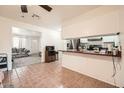 Open kitchen and living room area with light colored tile flooring and appliances at 5343 W Coronado Rd, Phoenix, AZ 85035