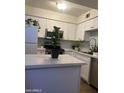 Bright kitchen features white cabinetry, stainless steel appliances, and light countertops at 602 N May St # 65, Mesa, AZ 85201