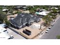 An aerial view shows a house under construction with a dark roof, light siding, and minimal landscaping at 6426 E Turquoise Ave, Paradise Valley, AZ 85253