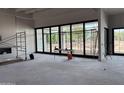 Spacious living room featuring large windows and unfinished flooring ready for customization at 6426 E Turquoise Ave, Paradise Valley, AZ 85253