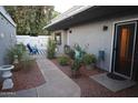 Landscaped backyard with lush green plants and a charming patio area at 8848 N New World Dr, Glendale, AZ 85302