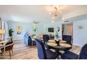 Open living and dining area with contemporary lighting, ceiling fan, and modern decor for a stylish and inviting atmosphere at 8848 N New World Dr, Glendale, AZ 85302