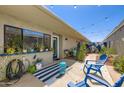 Private outdoor patio features a blue accent wall, string lights, and comfortable seating for relaxing and entertaining at 8848 N New World Dr, Glendale, AZ 85302