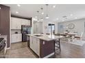 Open-concept kitchen with a large island, granite countertops, modern appliances, and an adjacent dining area at 10165 E Gamma Ave, Mesa, AZ 85212
