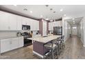 Spacious kitchen featuring a large island with seating, granite countertops, and stainless steel appliances at 10165 E Gamma Ave, Mesa, AZ 85212