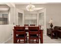 Dining room with wood table and chairs, large window letting in natural light at 1028 S Valle Verde --, Mesa, AZ 85208