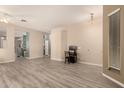 Spacious living area featuring gray wood flooring and neutral paint throughout at 1028 S Valle Verde --, Mesa, AZ 85208