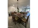 Spacious dining room area leading to an open-concept living space and outdoor patio at 12421 N 41St Pl, Phoenix, AZ 85032
