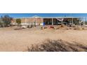 Exterior shot of the home with a porch and desert landscaping at 1347 S Oak Rd, Maricopa, AZ 85139