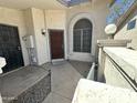 Inviting front porch with stylish stone, secure wrought iron door, and outdoor lighting at 1718 S Longmore St # 53, Mesa, AZ 85202