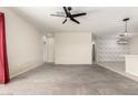 A large living room with ceramic tile flooring, a modern ceiling fan, and an adjacent kitchen at 1748 W Cameron Blvd, Coolidge, AZ 85128