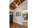 Inviting entryway featuring wood floors, a vaulted ceiling, and an open view to the living space at 1825 E Palo Verde Dr, Phoenix, AZ 85016