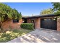 Charming single-story brick home featuring a manicured lawn and a one-car garage at 1825 E Palo Verde Dr, Phoenix, AZ 85016