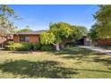 Cozy brick home with mature landscaping and a well-maintained front yard at 1825 E Palo Verde Dr, Phoenix, AZ 85016