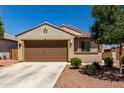 Single-story home featuring a two-car garage, desert landscaping, and a neutral color scheme at 20128 W Jackson St, Buckeye, AZ 85326