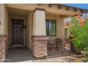 Inviting front porch with stone accents, seating area, and desert landscaping at 205 N 107Th Dr, Avondale, AZ 85323
