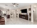 Spacious open-concept living area with tile flooring and a ceiling fan at 205 N 107Th Dr, Avondale, AZ 85323