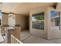 Inviting front porch featuring stylish pillars, stucco walls, and large windows at 20814 N Dries Rd, Maricopa, AZ 85138