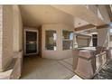 Inviting front porch featuring stylish pillars, stucco walls, and a secure security screen door at 20814 N Dries Rd, Maricopa, AZ 85138